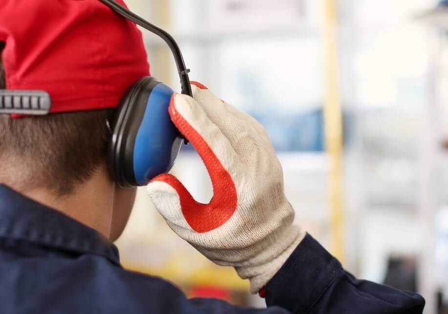 Man working in a noisy environment wearing ear muffs